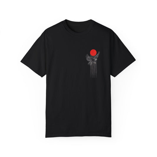 A black graphic t shirt showing a big eagle graphic shirts design on the back, with a red sun and lines that look like a cage. It’s a striking black and red graphic tee that feels powerful and free.