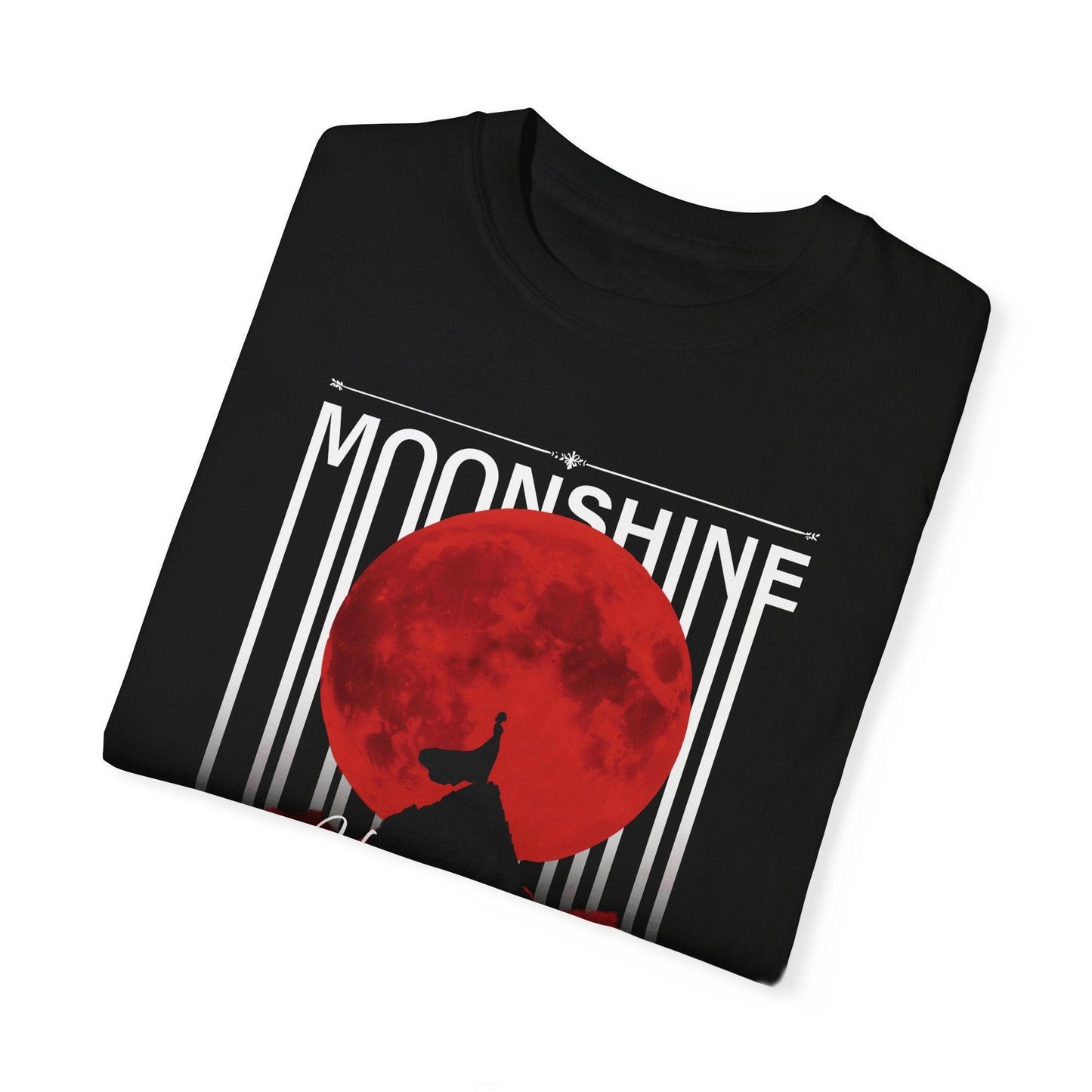 A folded black graphic t shirt showcasing a dark moon shirt design with a woman’s silhouette on a red moon, accented by "MOONSHINE" and "Bloodmoon" text. This moon magic shirt is ideal for night sky shirt lovers seeking an eclipse shirt with a gothic moon shirt flair.