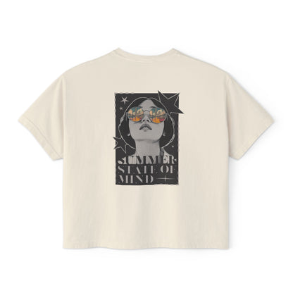 Alt text: Back of a trendy graphic t shirt featuring a bold retro-style illustration of a woman in sunglasses with a summer sunset reflection and "SUMMER STATE OF MIND" lettering