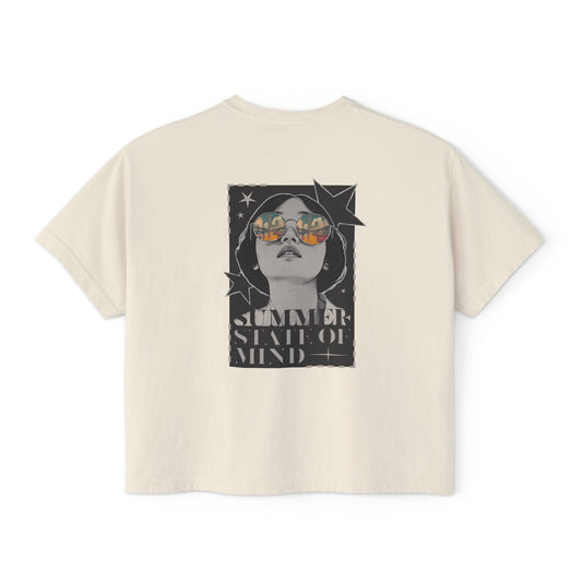 Alt text: Back of a trendy graphic t shirt featuring a bold retro-style illustration of a woman in sunglasses with a summer sunset reflection and "SUMMER STATE OF MIND" lettering